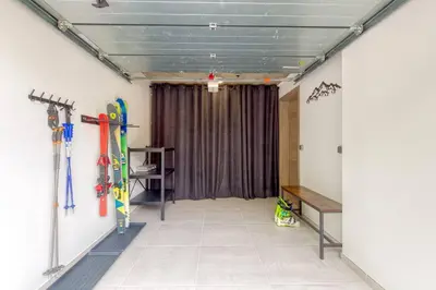 a room with skis and snowboards on the wall at Couchant Chalet Lumineux 6pax Vues Terrasses Confort in Chamonix-Mont-Blanc