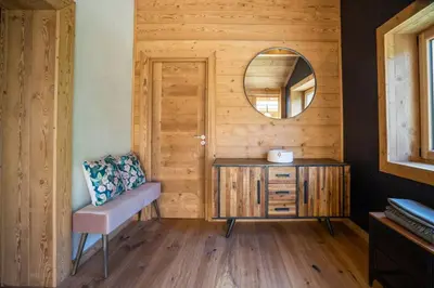 a bathroom with a mirror and a wooden wall at Eden Chalet Spacieux Vues Jacuzzi Cheminee BBQ in Chamonix-Mont-Blanc