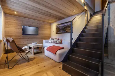a room with a staircase in a house at Eden Chalet Spacieux Vues Jacuzzi Cheminee BBQ in Chamonix-Mont-Blanc