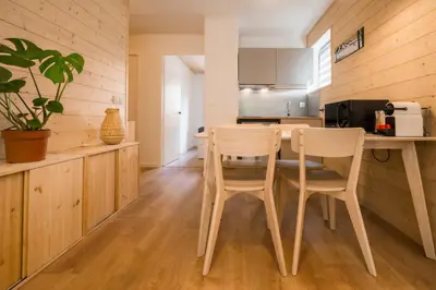 a kitchen with a table and two chairs in a room at Sapi Cocon 4pax Centre Jardin Remontees TV Wifi in Chamonix-Mont-Blanc