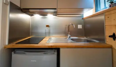 a kitchen with a sink and a counter top at Sapi Cocon 4pax Centre Jardin Remontees TV Wifi in Chamonix-Mont-Blanc
