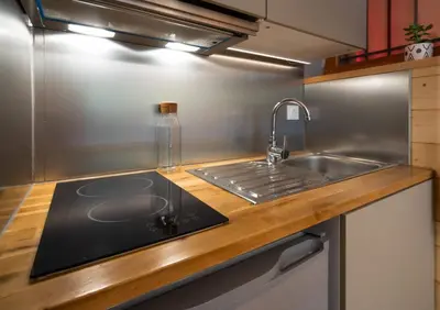 a kitchen with a sink and a counter top at Sapi Cocon 4pax Centre Jardin Remontees TV Wifi in Chamonix-Mont-Blanc