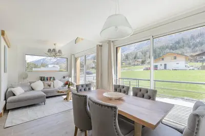 a dining room with a table and chairs and a couch at Levant Chalet Moderne 6pax Vues Terrasses Confort in Chamonix-Mont-Blanc