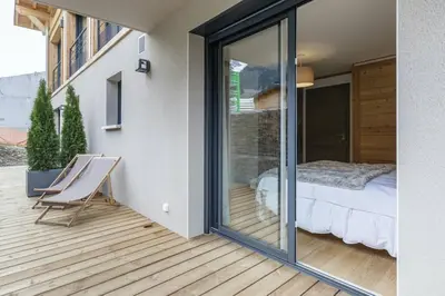 a room with a sliding glass door leading to a bedroom at Levant Chalet Moderne 6pax Vues Terrasses Confort in Chamonix-Mont-Blanc