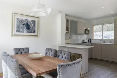 a kitchen and dining room with a wooden table and chairs at Levant Chalet Moderne 6pax Vues Terrasses Confort in Chamonix-Mont-Blanc