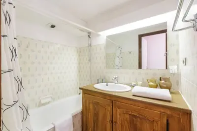 a bathroom with a sink and a bath tub at Argentero Cosy Duplex Pied Pistes Vue Grands Montets in Chamonix-Mont-Blanc