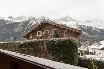 a house on top of a snow covered mountain at Etoile Cosy Balcon Vue Montagne Proche Centre in Chamonix-Mont-Blanc