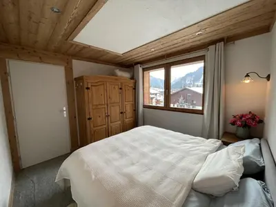a bedroom with a large bed and a window at Chalet Sablod in Les Contamines-Montjoie