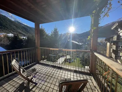 a balcony with a bench and a view of the mountains at Chalet Sablod in Les Contamines-Montjoie