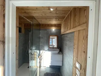 a bathroom with a glass shower and a sink at Chalet Sablod in Les Contamines-Montjoie