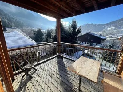 a balcony with a bench and a view of the mountains at Chalet Sablod in Les Contamines-Montjoie