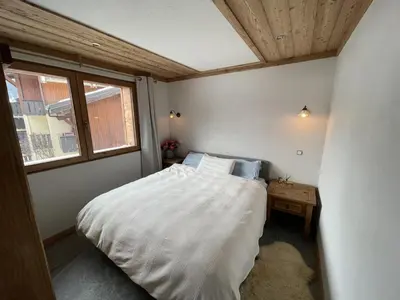 a small bedroom with a bed and a window at Chalet Sablod in Les Contamines-Montjoie
