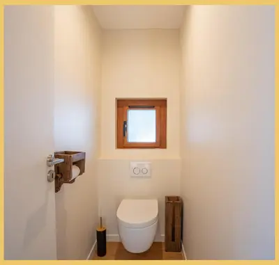 a bathroom with a toilet and a window at Le Balcon du Mont-BIanc I Duplex I Combloux in Combloux