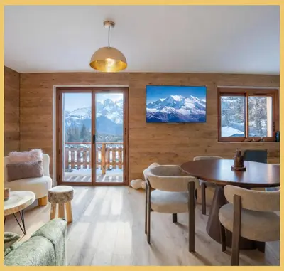 a living room with a table and views of mountains at Le Balcon du Mont-BIanc I Duplex I Combloux in Combloux