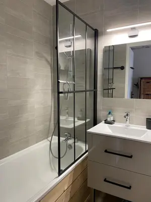 a bathroom with a shower and a sink and a tub at Cocon Saint-Gervais in Saint-Gervais-les-Bains