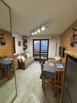 a living room with a couch and a table at Cocon Saint-Gervais in Saint-Gervais-les-Bains