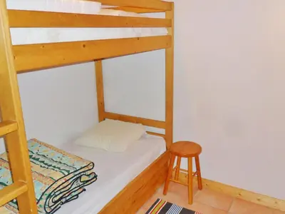 a bedroom with a bunk bed and a stool at Duplex à Samoëns, 6 pers, balcon sud, parking - FR-1-815-48 in Samoëns