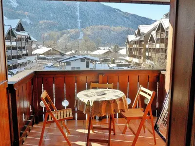 a table and chairs on a balcony with a view at Duplex à Samoëns, 6 pers, balcon sud, parking - FR-1-815-48 in Samoëns