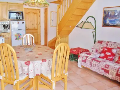 a kitchen and dining room with a table and a bed at Duplex à Samoëns, 6 pers, balcon sud, parking - FR-1-815-48 in Samoëns
