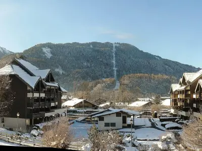 a town with snow covered buildings and a mountain at Duplex à Samoëns, 6 pers, balcon sud, parking - FR-1-815-48 in Samoëns