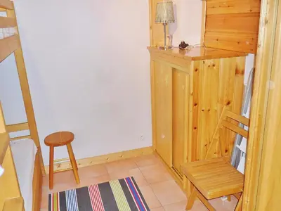 a small room with a chair and a wooden cabinet at Duplex à Samoëns, 6 pers, balcon sud, parking - FR-1-815-48 in Samoëns