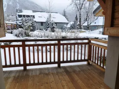 a wooden balcony with snow on the ground at Appartement neuf 3 pièces - 6 pers - Vue montagne - FR-1-815-49 in Samoëns