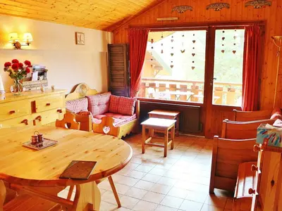 a living room with a table and a couch at Charmant appartement à Samoëns pour 8 pers avec balcon - FR-1-815-112 in Samoëns