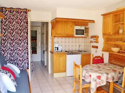 a kitchen with a table and a dining room at Studio cosy avec balcon à Samoëns, parking inclus, pour 4 pers. - FR-1-815-114 in Samoëns