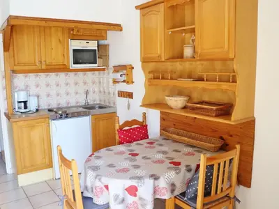 a kitchen with a table and a small kitchen with a table and chairs at Studio cosy avec balcon à Samoëns, parking inclus, pour 4 pers. - FR-1-815-114 in Samoëns
