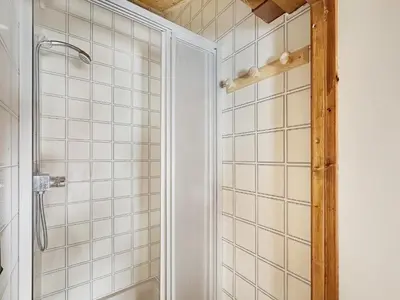 a bathroom with a shower with white tiled walls at ES117 - Duplex 6 pers pied de pistes in Les Carroz d'Araches