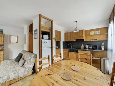 a kitchen and dining room with a wooden table at ES117 - Duplex 6 pers pied de pistes in Les Carroz d'Araches
