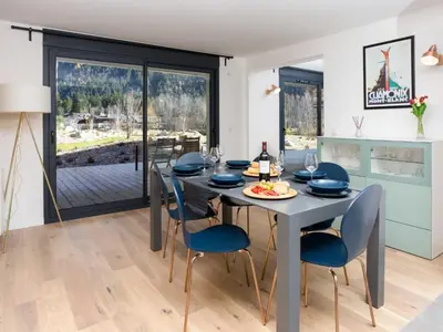a kitchen and dining room with a table and chairs at Apartment La Cordee 504 mit Terrasse by Interhome in Chamonix-Mont-Blanc