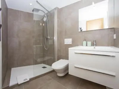 a bathroom with a shower and a toilet and a sink at Apartment La Cordee 504 mit Terrasse by Interhome in Chamonix-Mont-Blanc