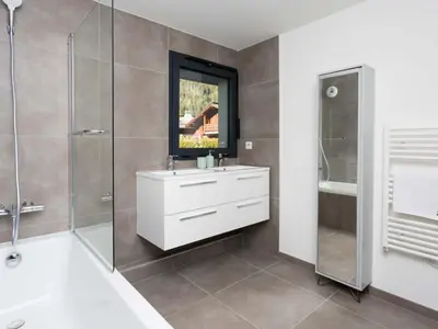a bathroom with a white sink and a shower at Apartment La Cordee 504 mit Terrasse by Interhome in Chamonix-Mont-Blanc