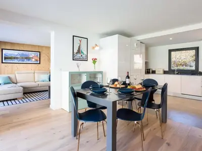 a dining room and living room with a table and chairs at Apartment La Cordee 504 mit Terrasse by Interhome in Chamonix-Mont-Blanc