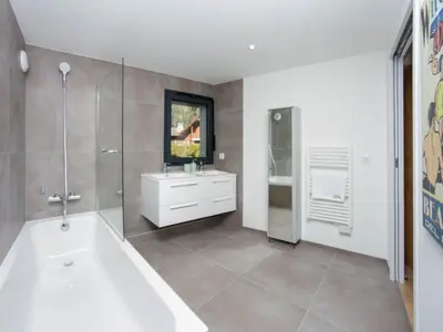 a bathroom with a tub and a sink at Apartment La Cordee 504 mit Terrasse by Interhome in Chamonix-Mont-Blanc