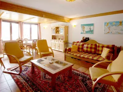 a living room with a couch and chairs and a table at Apartment Charmante Wohnung in Chamonix mit Südbalkon und Blick auf den Blanc by Interhome in Chamonix-Mont-Blanc