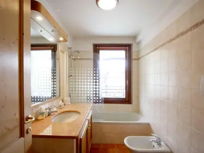 a bathroom with a sink and a bath tub and a sink at Apartment Charmante Wohnung in Chamonix mit Südbalkon und Blick auf den Blanc by Interhome in Chamonix-Mont-Blanc