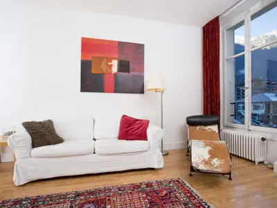 a living room with a white couch and a chair at Apartment Wohnung in Chamonix by Interhome in Chamonix-Mont-Blanc