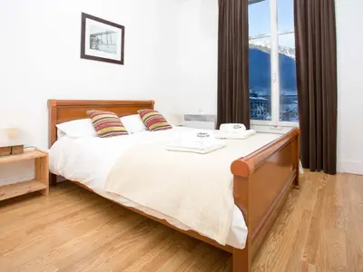 a bedroom with a bed and a large window at Apartment Wohnung in Chamonix by Interhome in Chamonix-Mont-Blanc