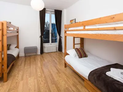 two bunk beds in a room with wooden floors at Apartment Wohnung in Chamonix by Interhome in Chamonix-Mont-Blanc
