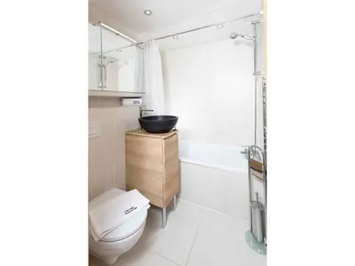 a bathroom with a sink and a toilet and a tub at Apartment Ginabelle 8 Wohnung by Interhome in Chamonix-Mont-Blanc