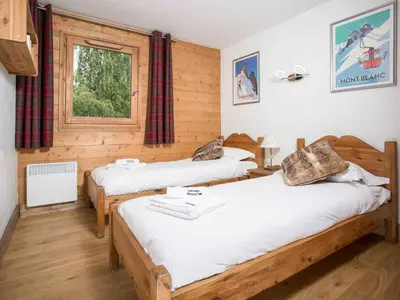 a room with two beds and a window at Apartment Ginabelle 8 Wohnung by Interhome in Chamonix-Mont-Blanc