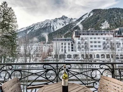 a bottle of wine sitting on a table on a balcony at Apartment Wohnung in Chamonix mit sonnigem Balkon und toller Aussicht by Interhome in Chamonix-Mont-Blanc