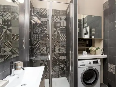 a bathroom with a shower and a washing machine at Apartment in Chamonix und Bergblick by Interhome in Chamonix-Mont-Blanc
