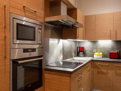 a kitchen with a stove and a microwave at Apartment in Chamonix und Bergblick by Interhome in Chamonix-Mont-Blanc