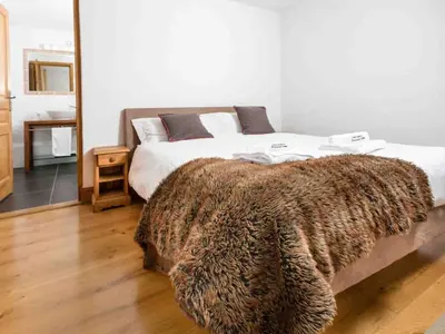 a bedroom with a bed with a faux fur blanket at Apartment Komfortable Wohnung in Chamonix mit Südterrasse by Interhome in Chamonix-Mont-Blanc