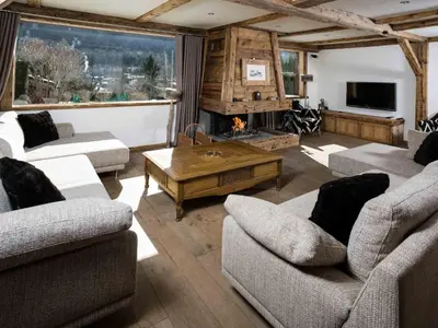 a living room with two couches and a fireplace at Holiday Home Chalet Martinique by Interhome in Chamonix-Mont-Blanc