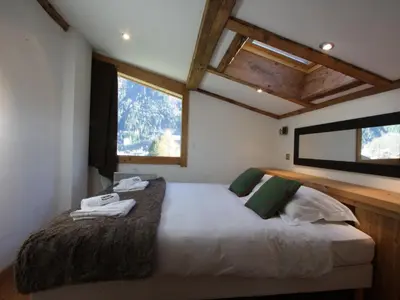 a bedroom with a large bed in a house at Holiday Home Chalet Martinique by Interhome in Chamonix-Mont-Blanc