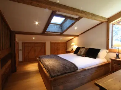 a bedroom with a bed in a room with a window at Holiday Home Chalet Martinique by Interhome in Chamonix-Mont-Blanc